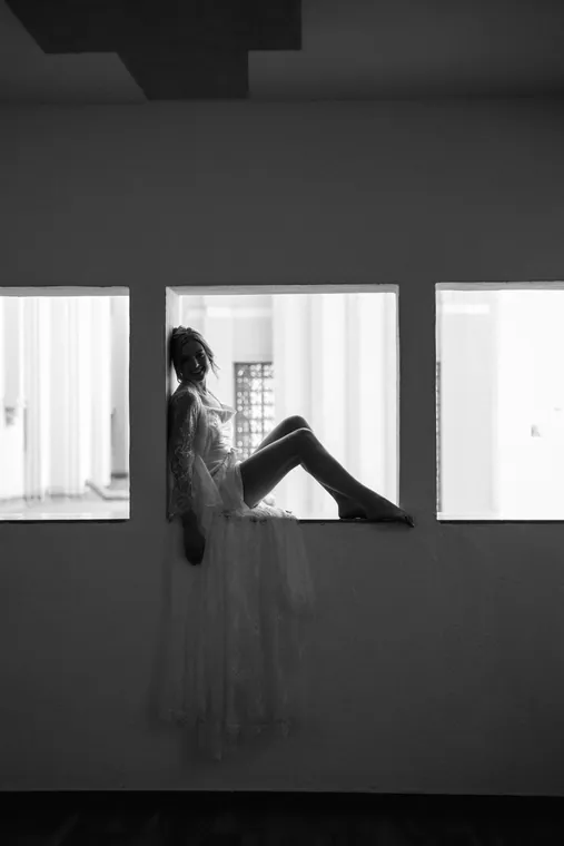 Black and white silhouette framed in a bright window